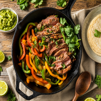 Cooked Angus beef fajita strips with peppers and onions from Diamond B Ranch